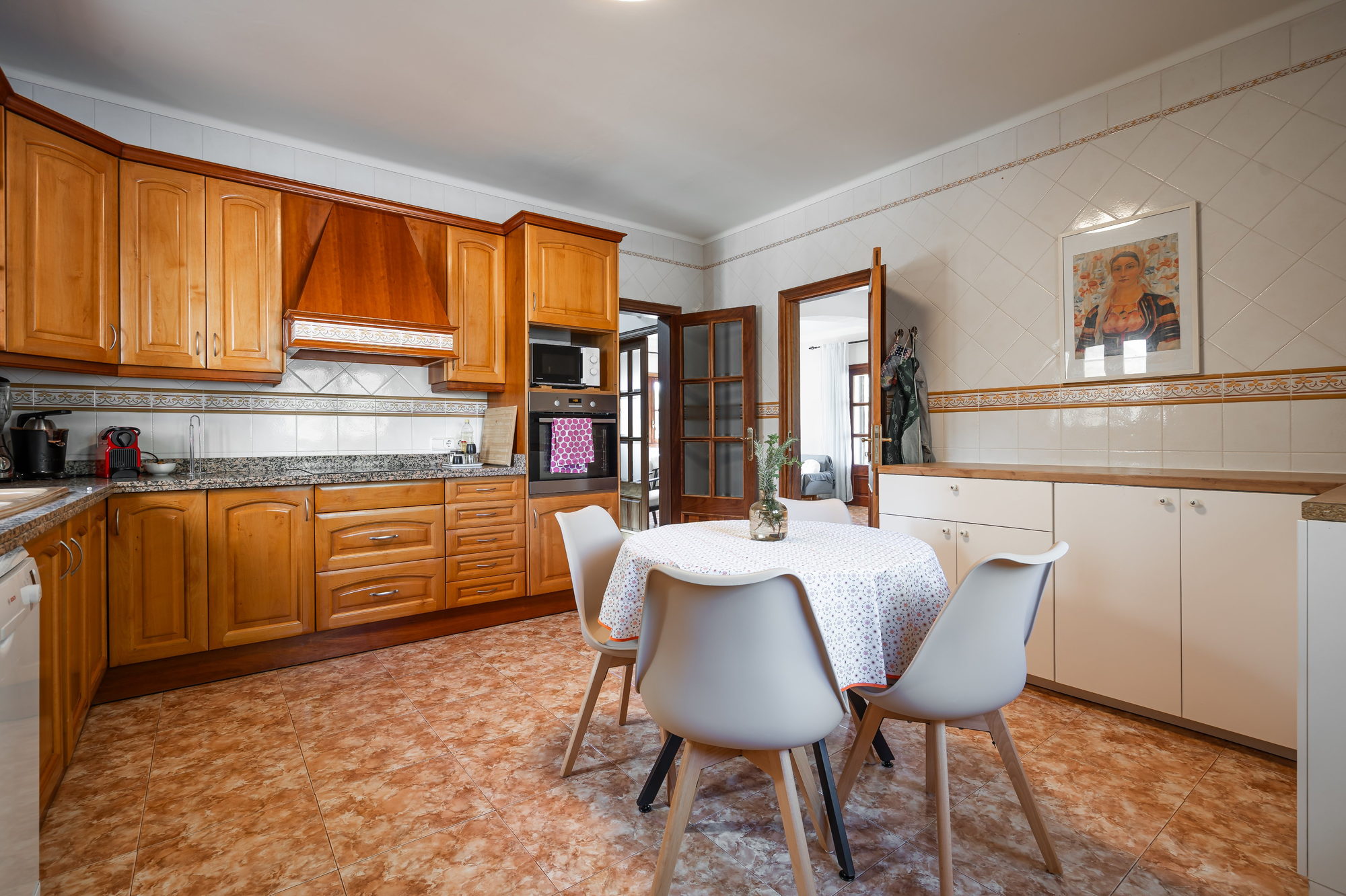 Kitchen with wooden cabinets and a round dining table