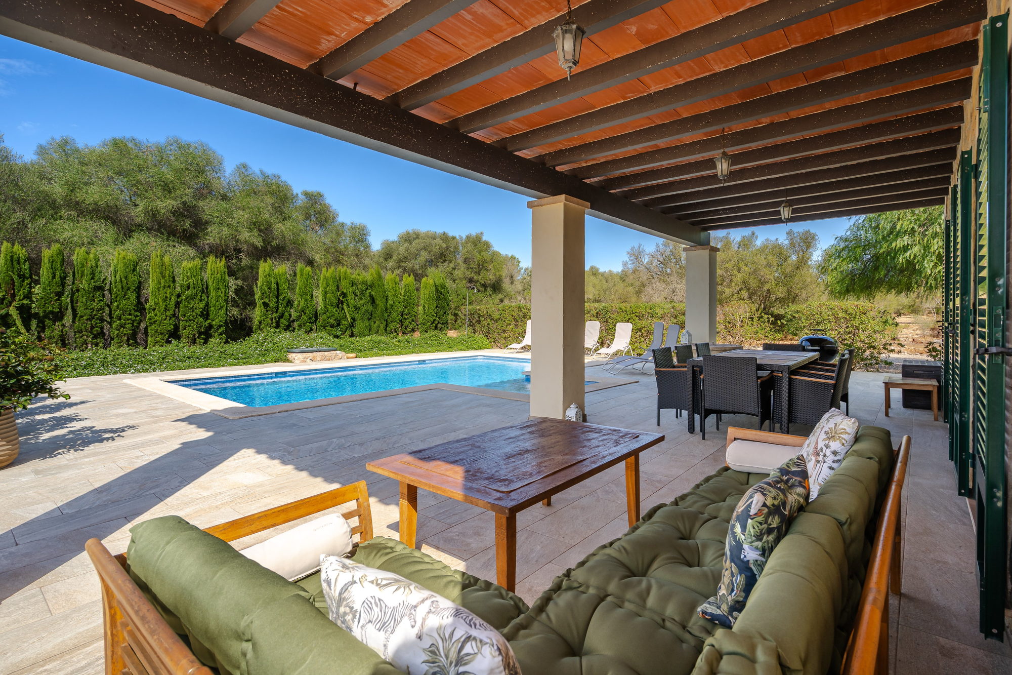 Covered terrace sofas looking over the pool